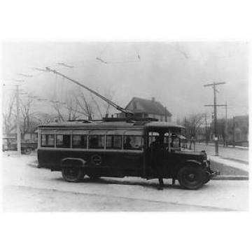 Man,trackless trolley car,bus,bearing insignia,Rochester Railway Bus Lines,c1920